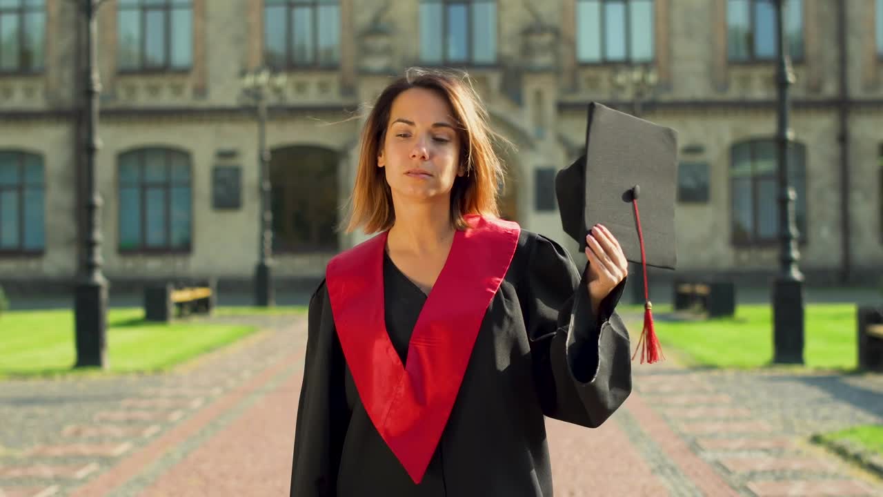 Stock Video Graduate Student In Gown Holding Hat Outside University Live Wallpaper For PC - Free Download