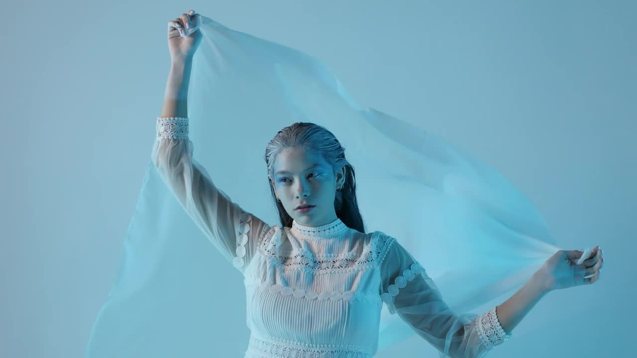 Stock Video Cold And Pale Looking Woman On A Blue Background Live Wallpaper For PC - Free Download