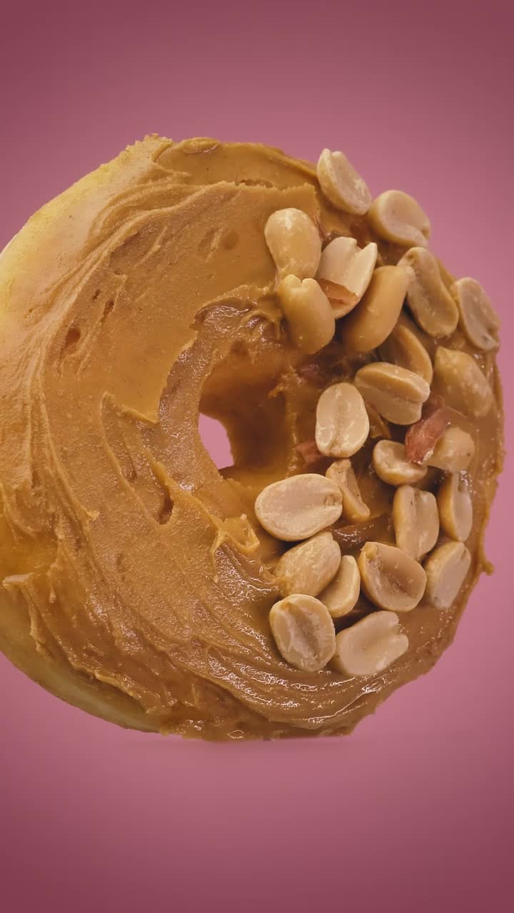 Stock Video Donut With Peanut Butter And Peanuts On A Pink Background Live Wallpaper For PC - Free Download