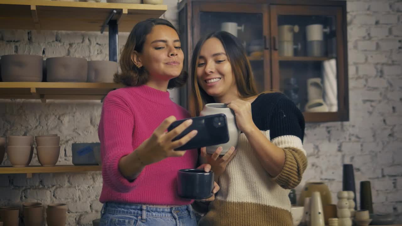 Stock Video Lgbtq Girlfriends Taking A Selfie In A Pottery Shop Animated Wallpaper - Free Download
