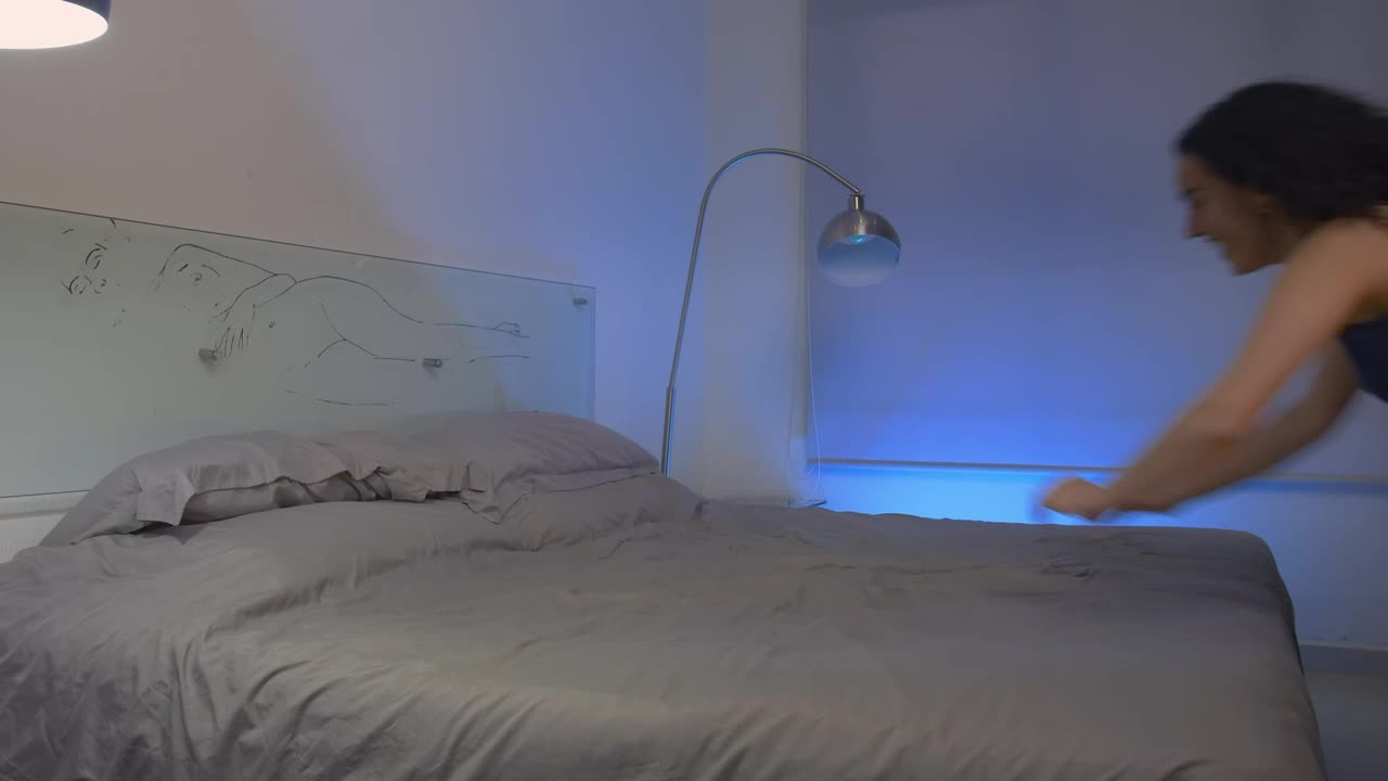 Stock Video Happy Girl Throws Herself On A Bed Animated Wallpaper - Free Download