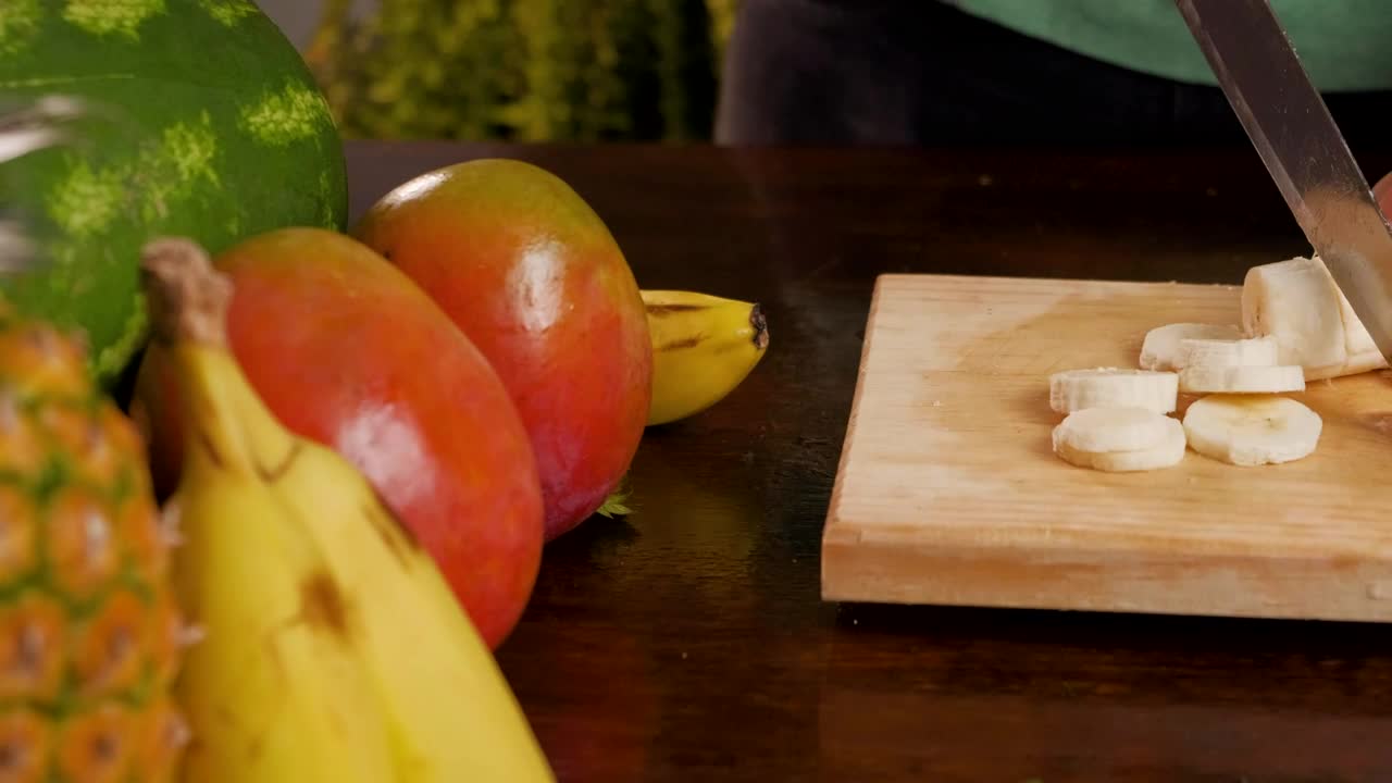 Stock Video Person Cutting Banana For A Fruit Cocktail Live Wallpaper - Free Download
