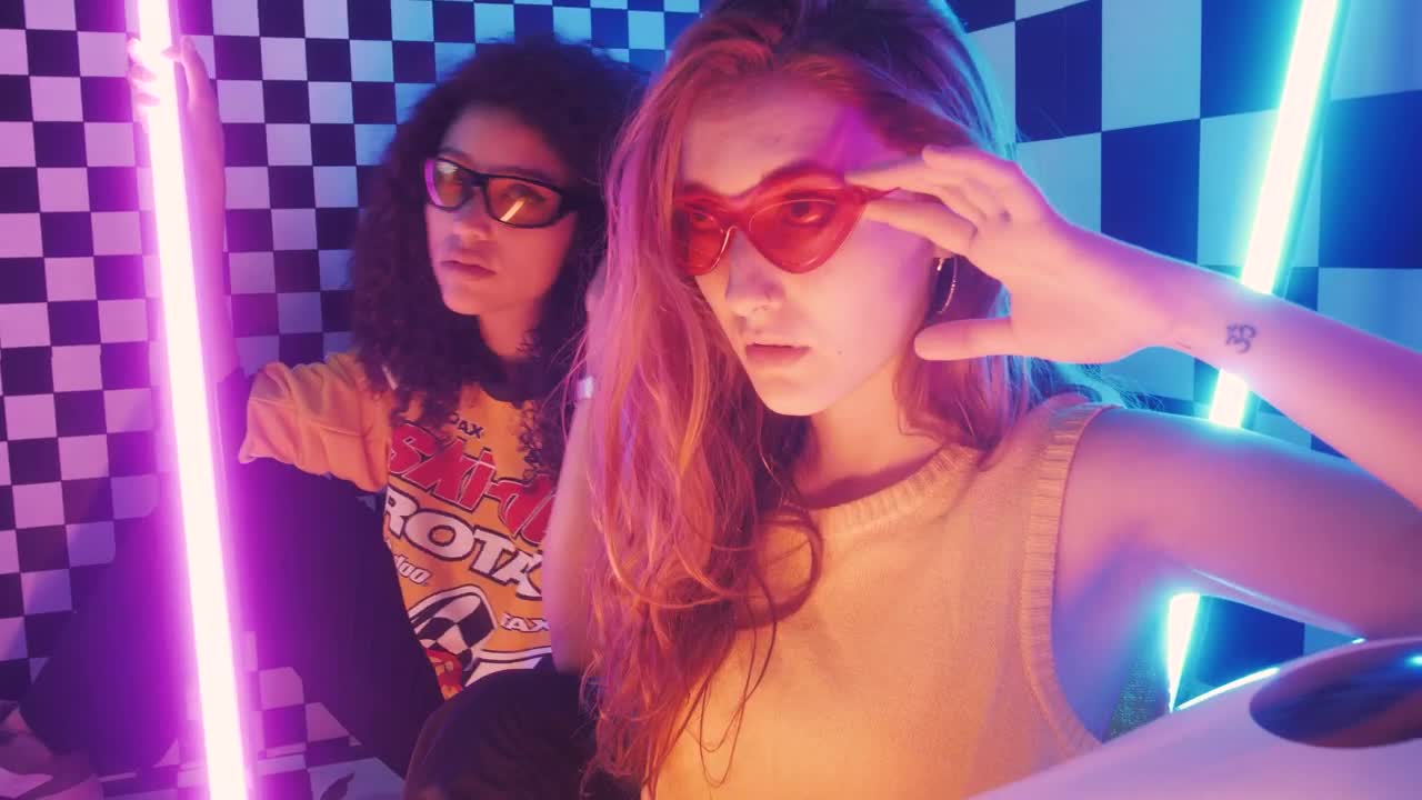 Stock Video Pair Of Stylish Girls Posing Captivatingly Live Wallpaper - Free Download