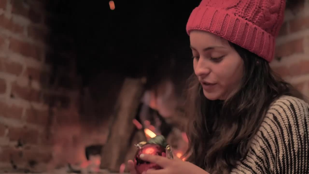 Stock Video Girl Decorating Christmas Tree Next To A Fireplace Live Wallpaper For PC - Free Download