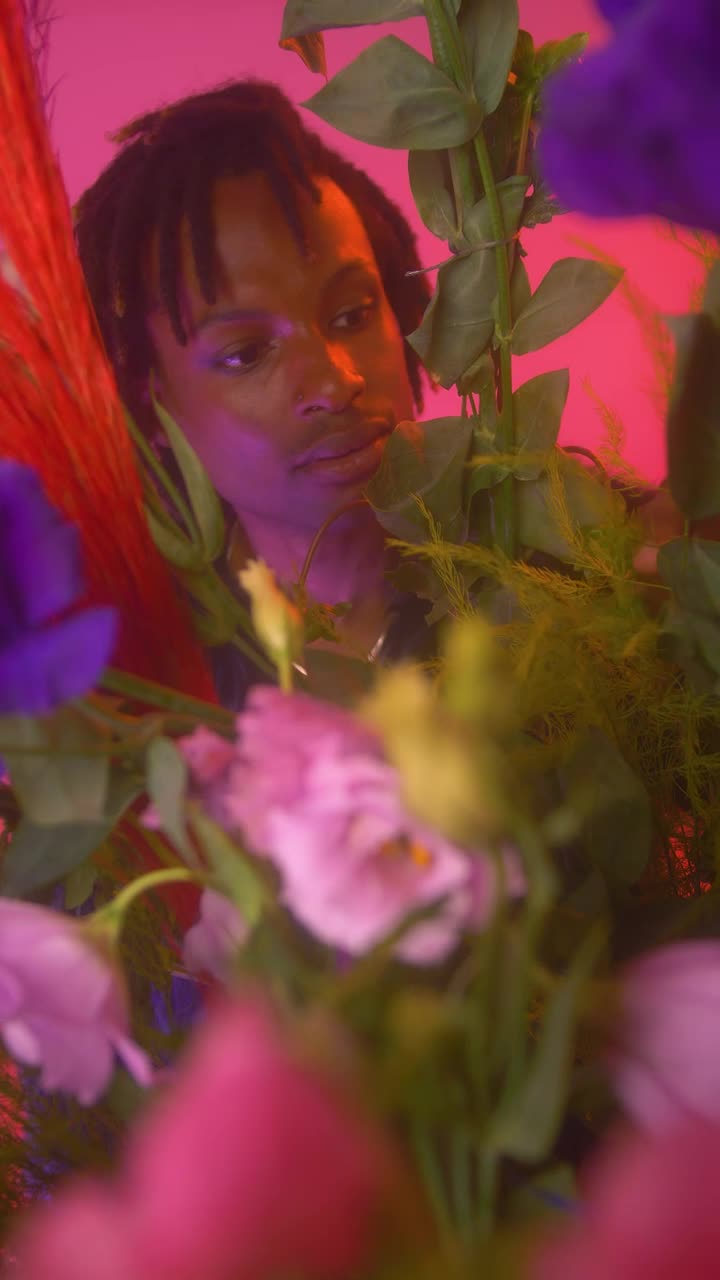 Stock Video Lgbtq Boy Looking At Camera Surrounded By Flowers Animated Wallpaper - Free Download