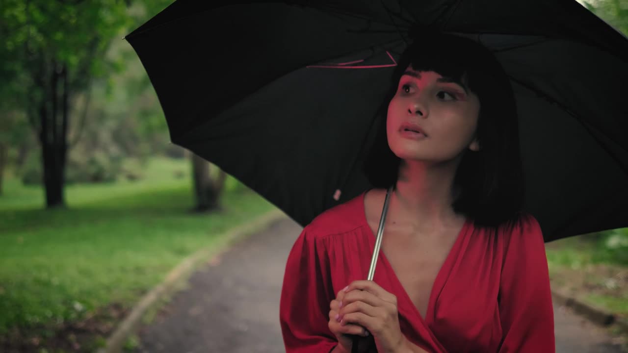 Stock Video Girl With An Umbrella Walking Through A Park Live Wallpaper For PC - Free Download