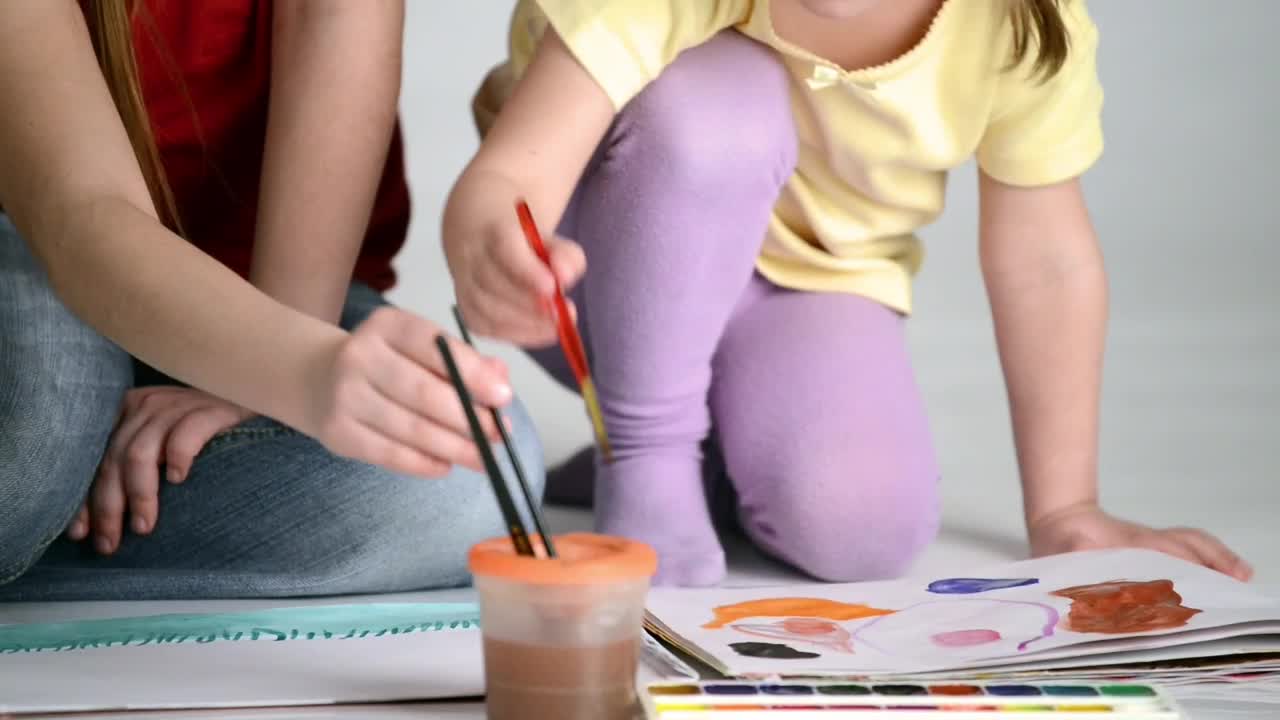Stock Video Mother Helps To Paint Her Daughter With Watercolo Animated Wallpaper - Free Download