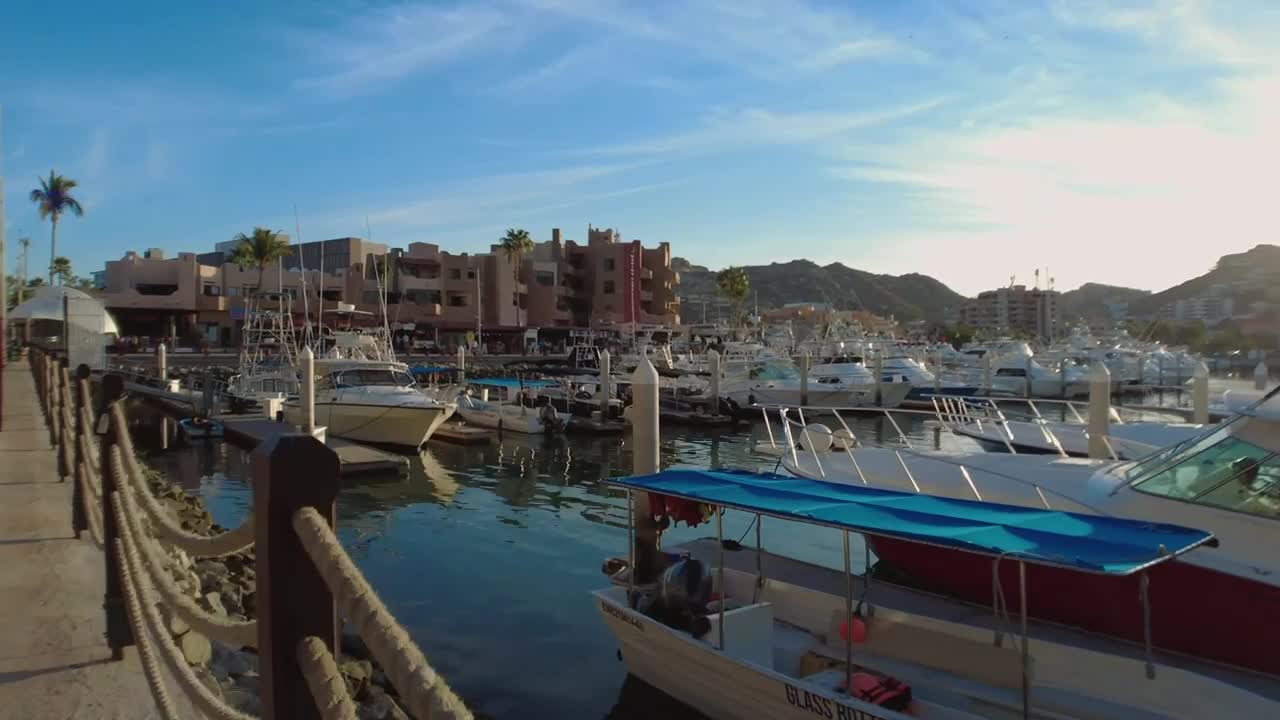 Free Video Stock touring a touristy and sunny port with boats and sailboats Live Wallpaper - Free Download