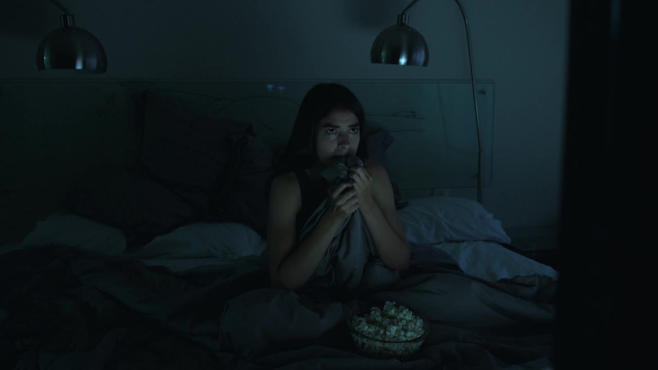 Stock Video Girl Watching A Horror Movie In Her Bedroom With The Live Wallpaper For PC - Free Download