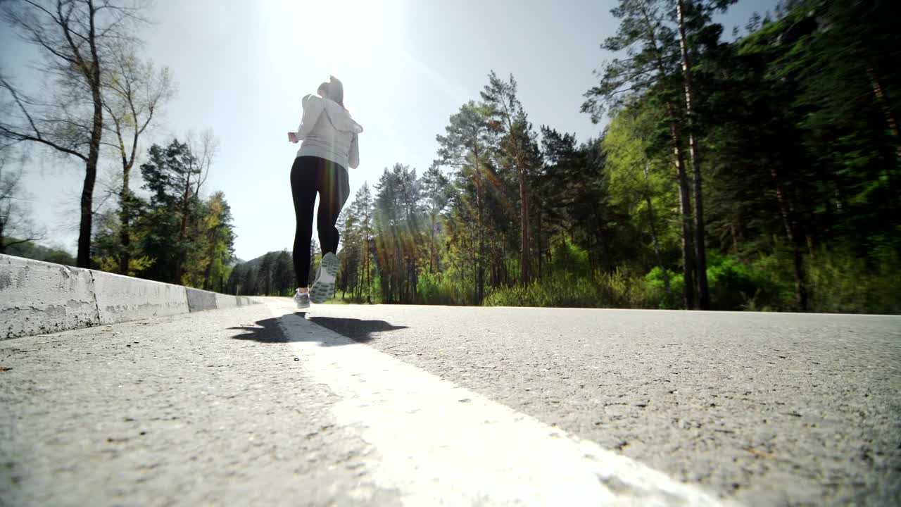 Stock Video Low Angle Of Runner Jogging On Forest Road Animated Wallpaper - Free Download
