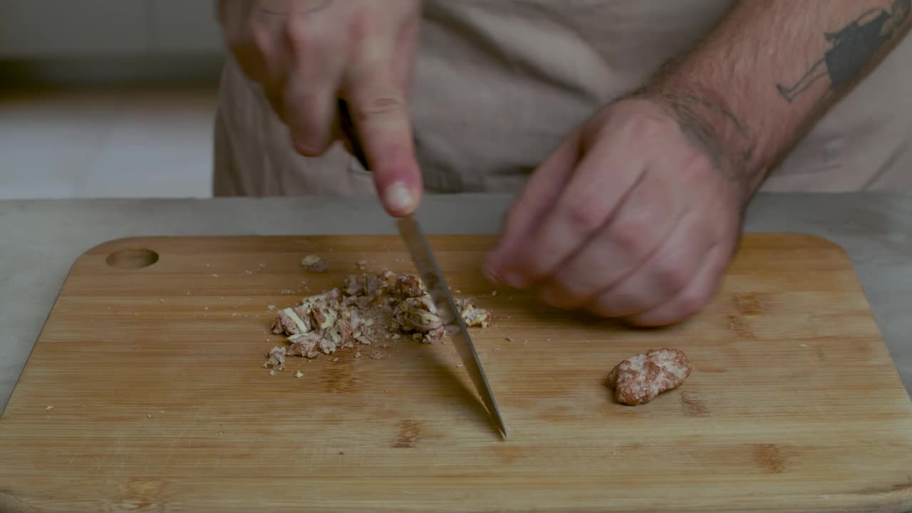 Stock Video Man Chopping Walnuts On A Wooden Board Animated Wallpaper - Free Download