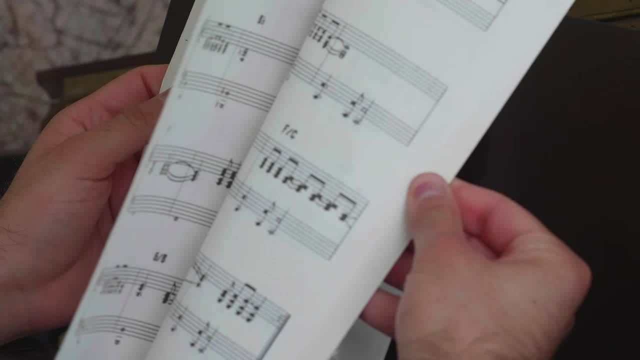 Stock Video Leafing Through A Notebook With Sheet Music Animated Wallpaper - Free Download