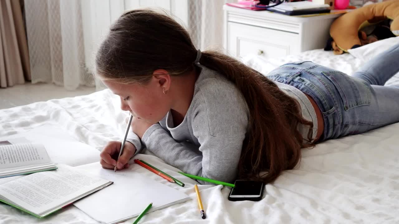 Stock Video Girl Doing Her Homework On Her Bed Live Wallpaper For PC - Free Download