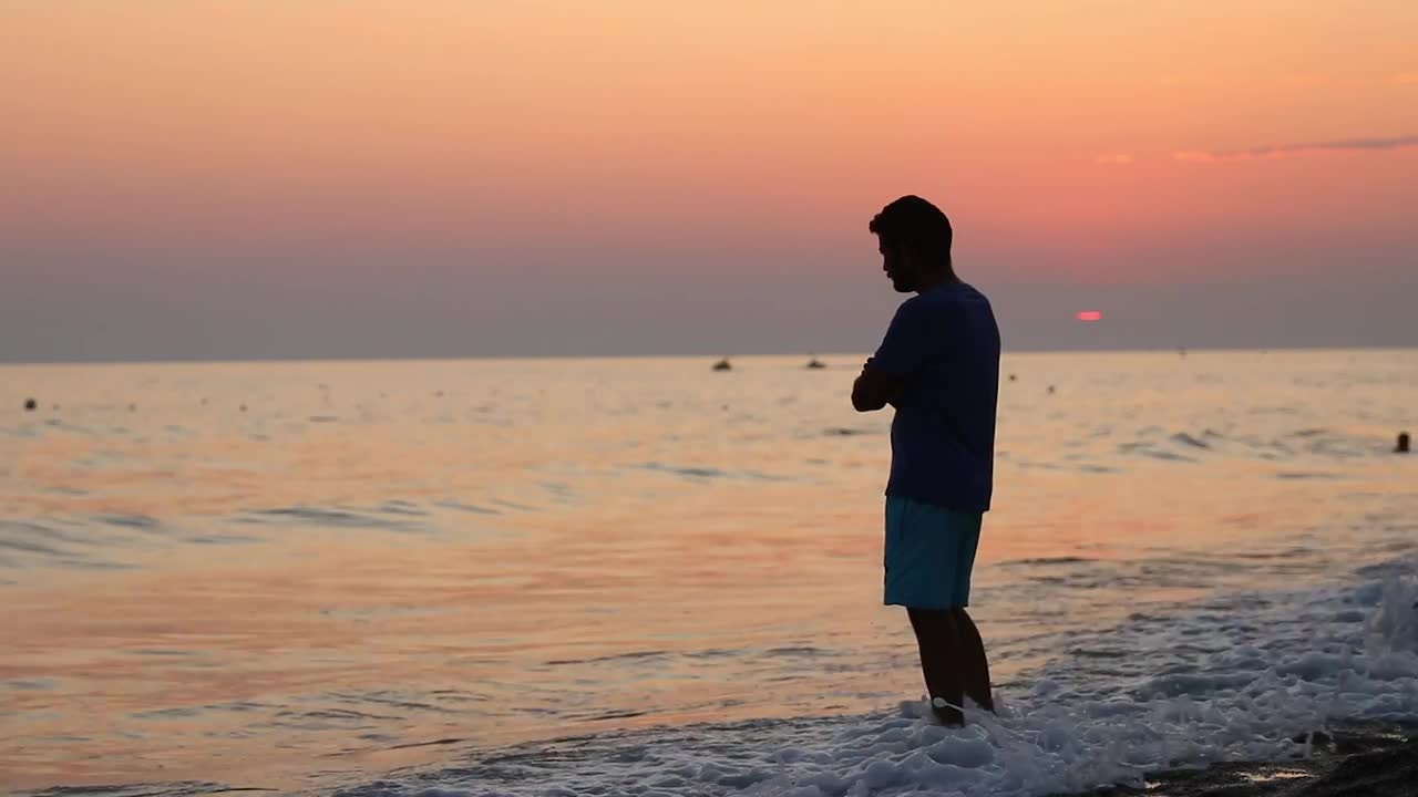 Stock Video Meditative Man On The Shore Of A Beach At Sunse Animated Wallpaper - Free Download