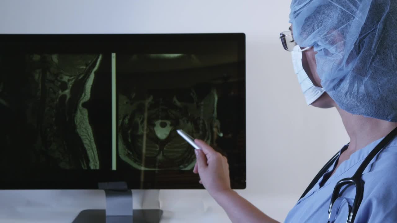 Stock Video Doctor Looking At A Brain Scan On A Dark Screen Live Wallpaper For PC - Free Download