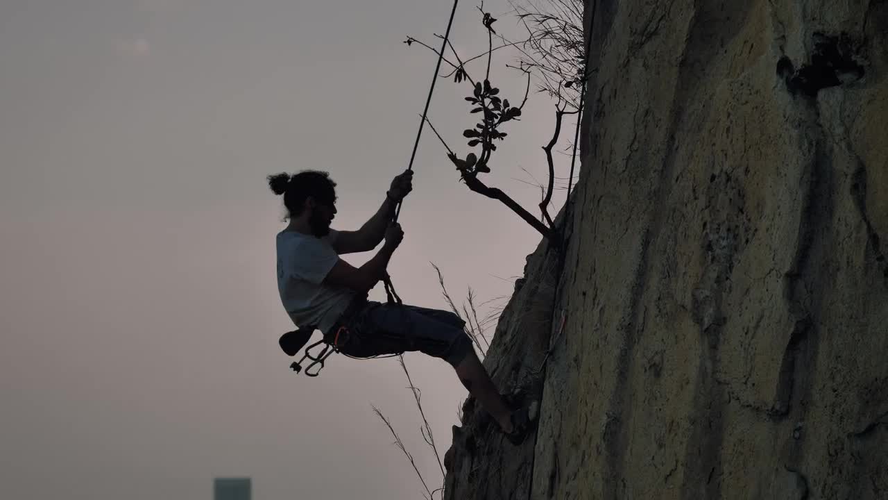 Free Video Stock Skilled Mountaineer Descending From A Mountain With A Rope Live Wallpaper - Free Download