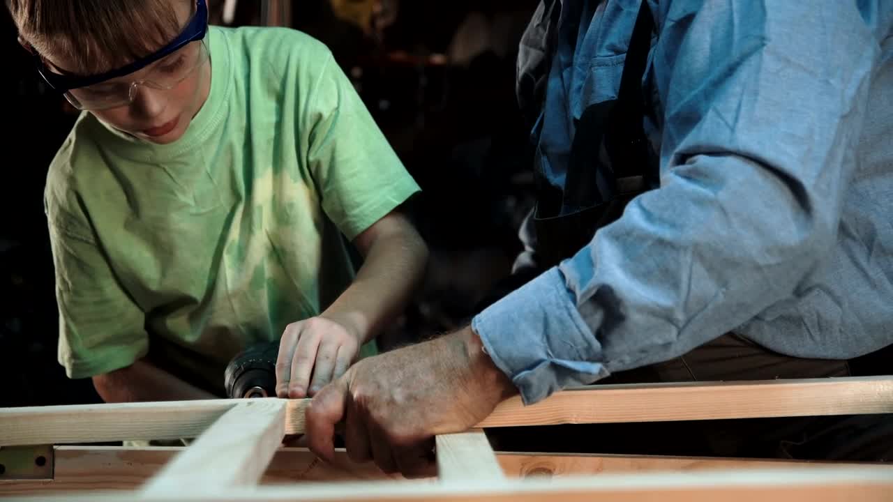 Stock Video Grandfather And Grandson Working On A Project Live Wallpaper For PC - Free Download