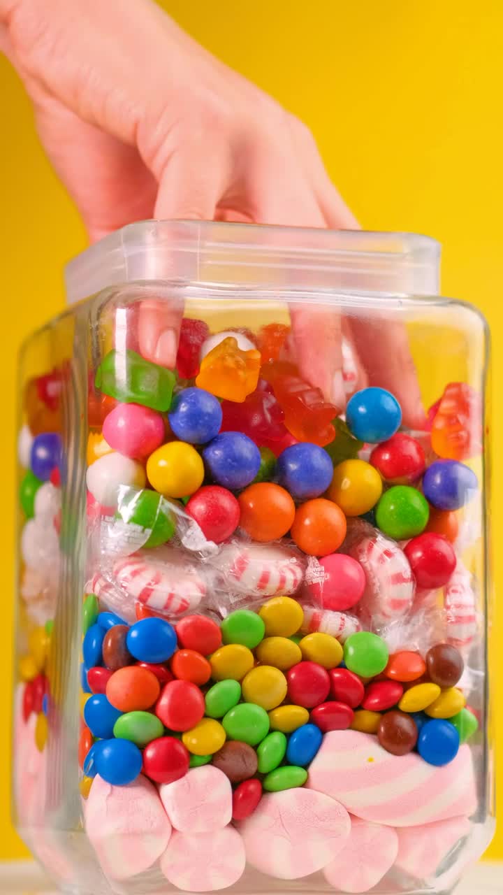 Free Video Stock taking candy from a pot that is on a yellow Live Wallpaper - Free Download