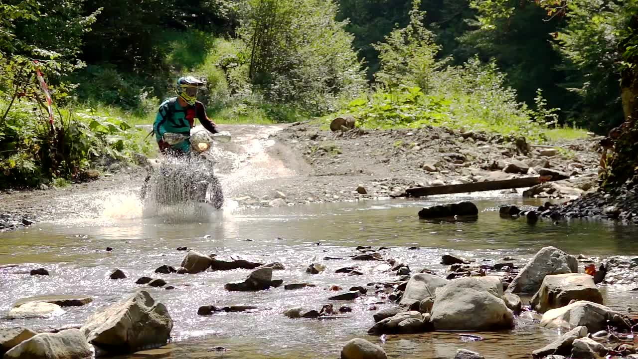 Stock Video Motocross Rider Crosses A River In The Mountain Live Wallpaper - Free Download