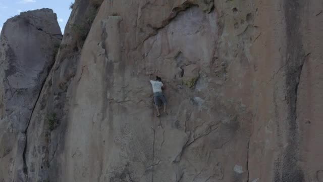 Stock Video Man Doing Mountaineering On A Large Rocky Mountain Smal Animated Wallpaper - Free Download