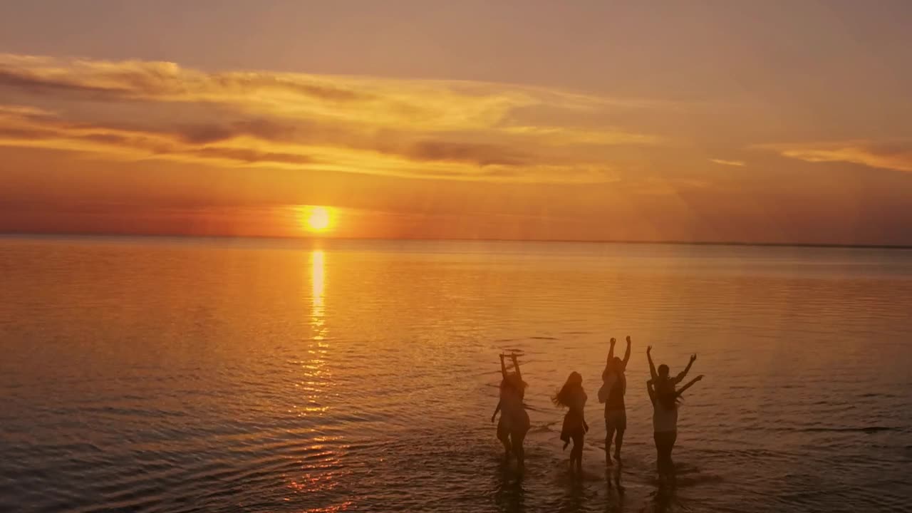 Stock Video Dreamy Sunset View Of People Jumping On Sea Surface Live Wallpaper For PC - Free Download