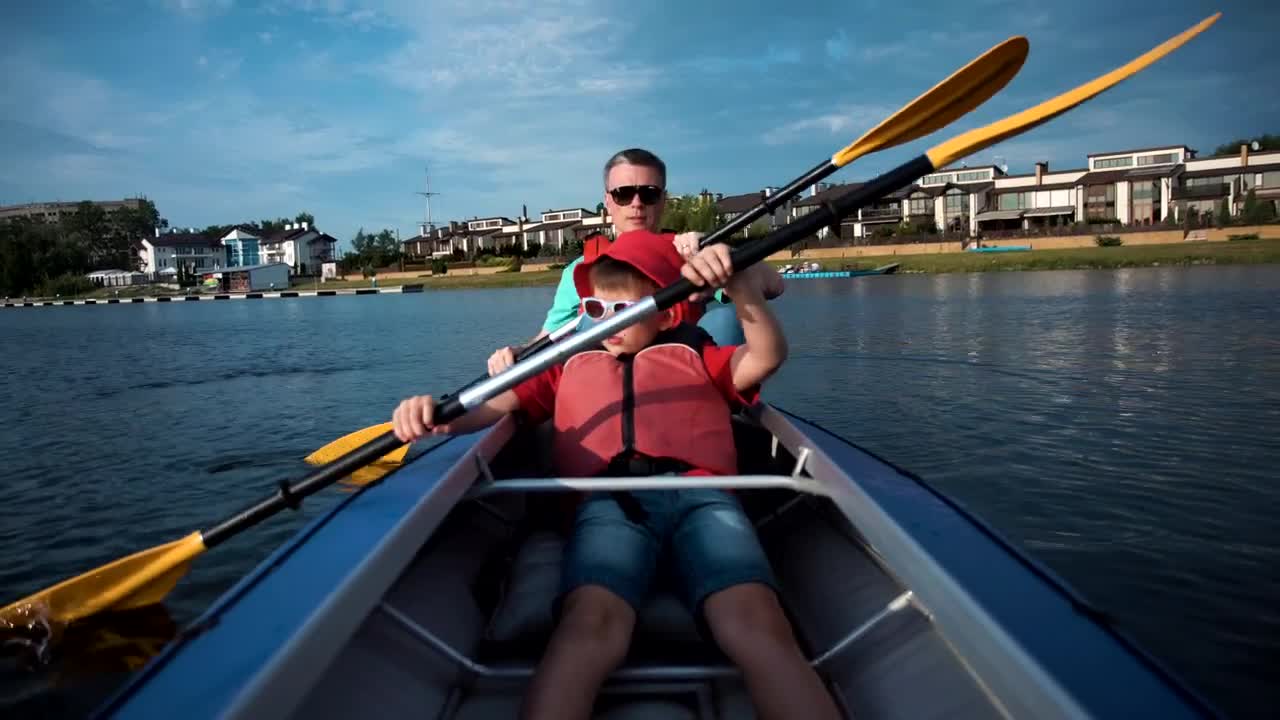 Stock Video Man And Son Doing Kayak On A Sunny Day Animated Wallpaper - Free Download