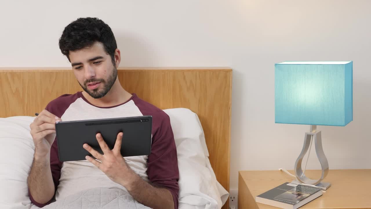 Stock Video Man Lying On Bed Drawing On A Table Animated Wallpaper - Free Download