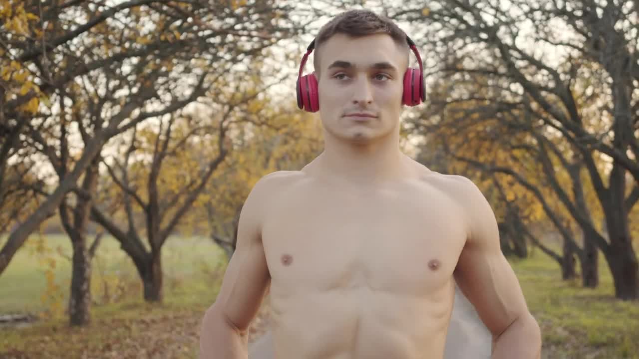 Free Stock Video Shirtless Man In Headphones Flexes Muscles Before Outdoor Workout Live Wallpaper - Free Download