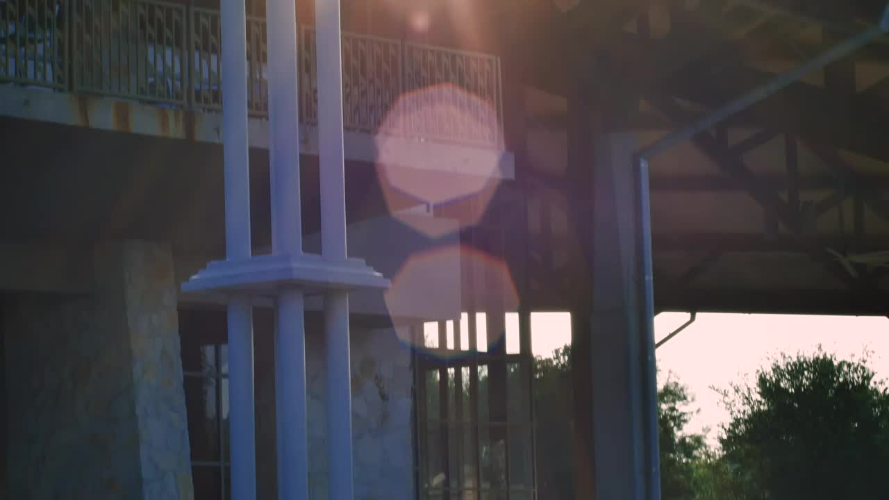 Stock Video People Hanging Out In A Building Surrounded By A Park Live Wallpaper - Free Download