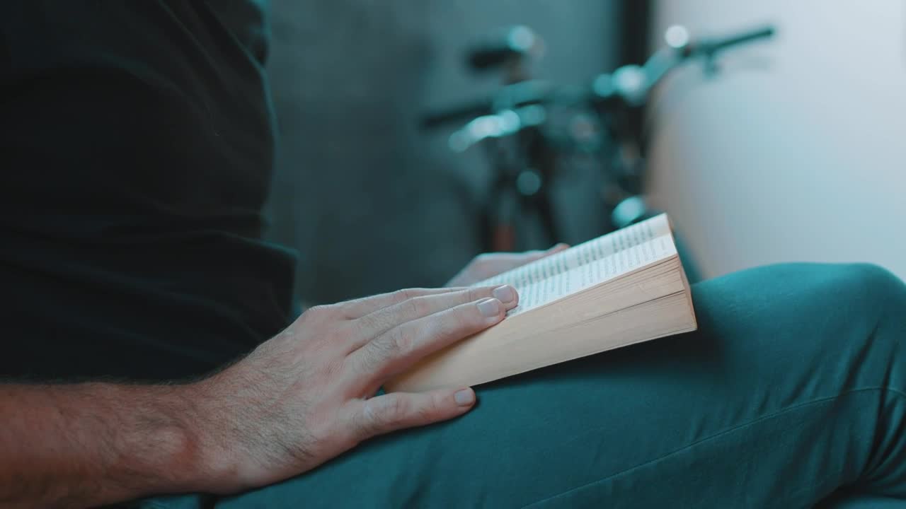 Stock Video Hipster Reading A Book Next To A Bicycle Animated Wallpaper - Free Download