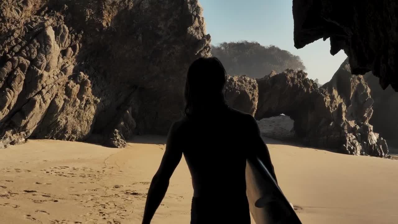 Free Video Stock surfer walking on the beach holding his board Live Wallpaper - Free Download