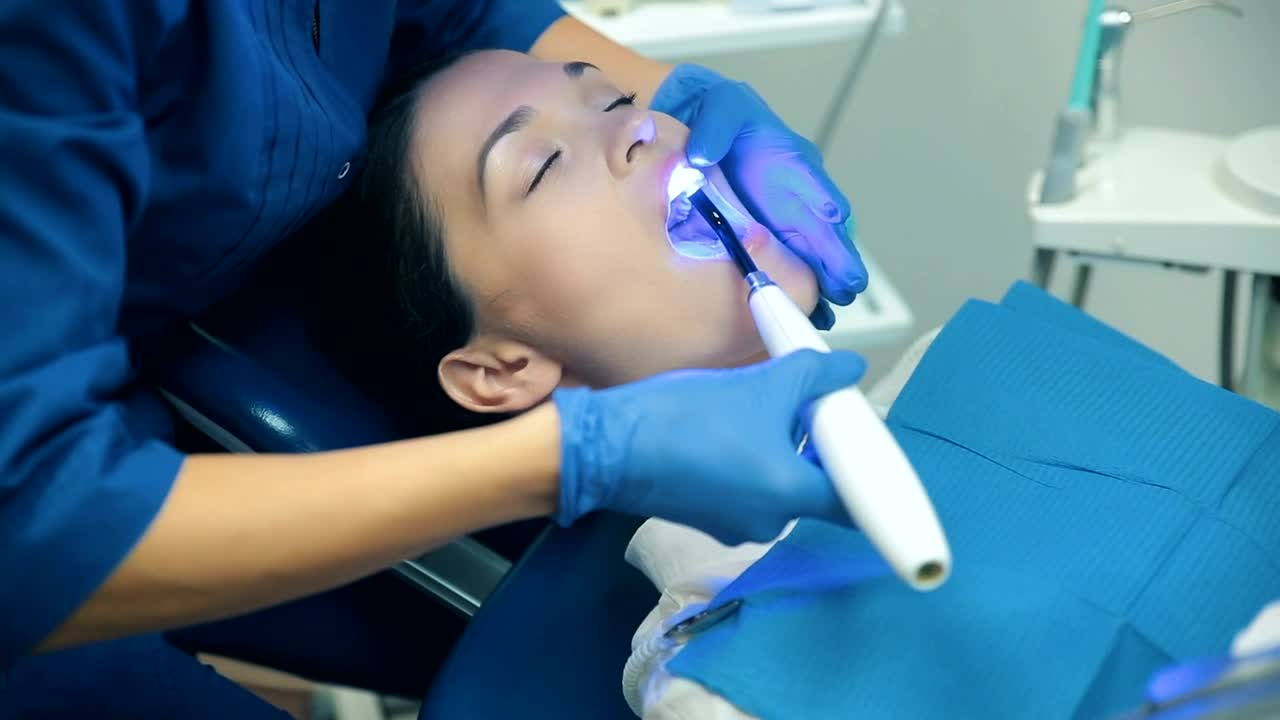Stock Video Dentist Applying Blue Light To His Patient Live Wallpaper For PC - Free Download