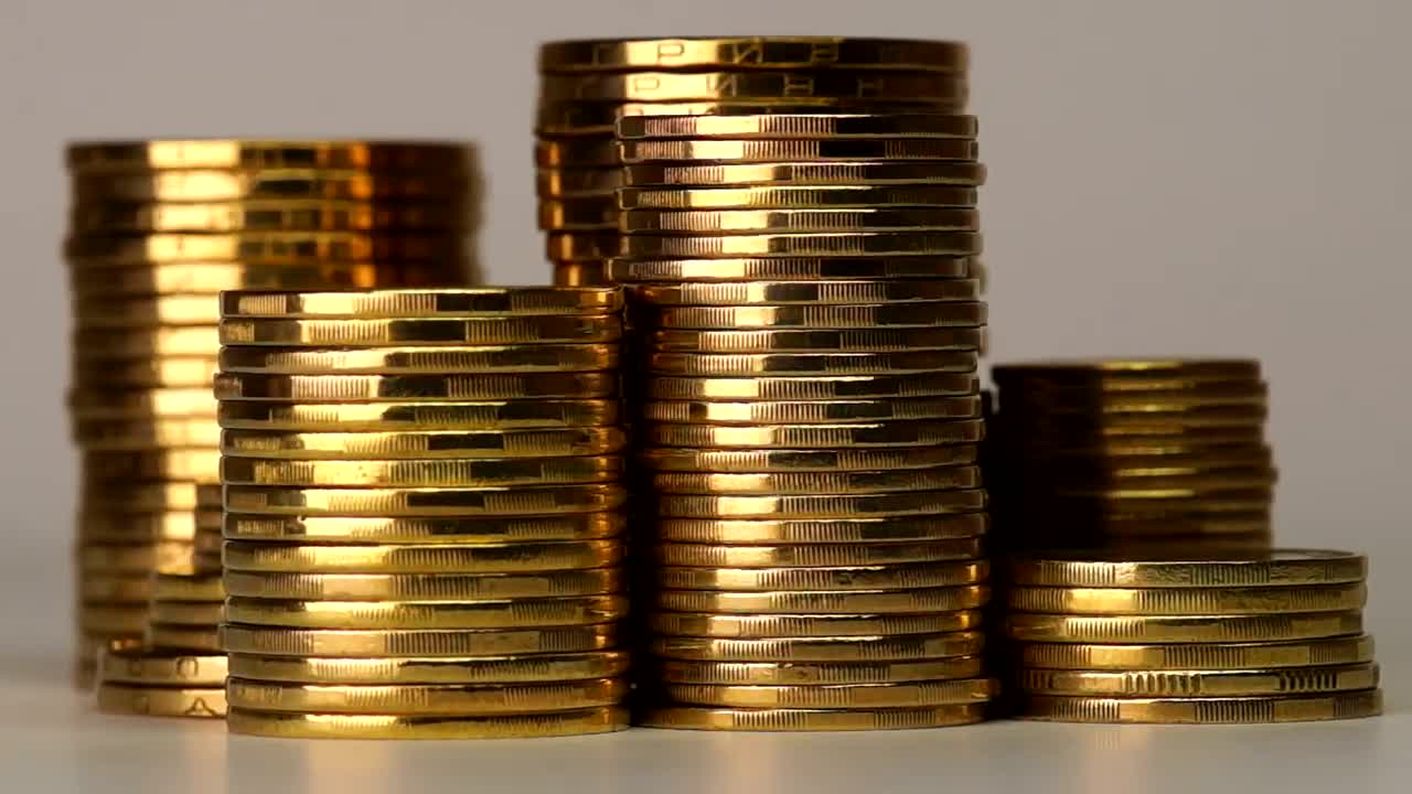 Free Video Stock towers of golden coins rotating on a gray background Live Wallpaper - Free Download