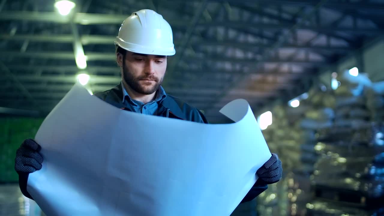 Stock Video Engineer Holding A Blueprint In A Warehouse Live Wallpaper For PC - Free Download