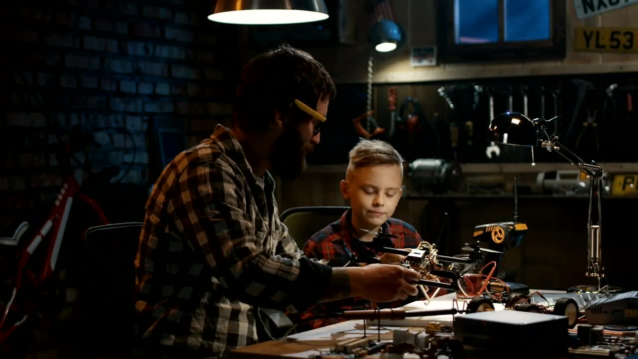 Stock Video Father And Son Repairing A Drone Live Wallpaper For PC - Free Download