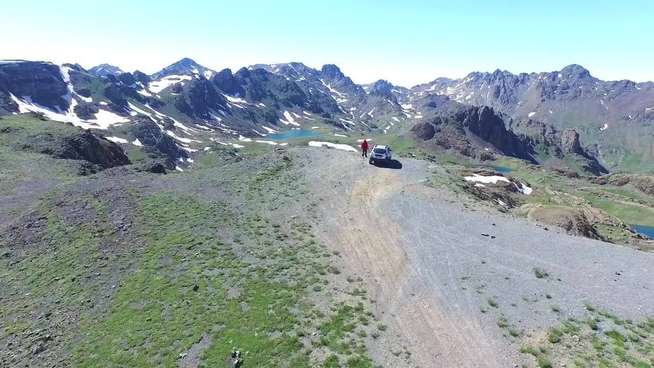 Video Stock Car And Man On A Mountain Peak Looking To The Live Wallpaper For PC - Free Download