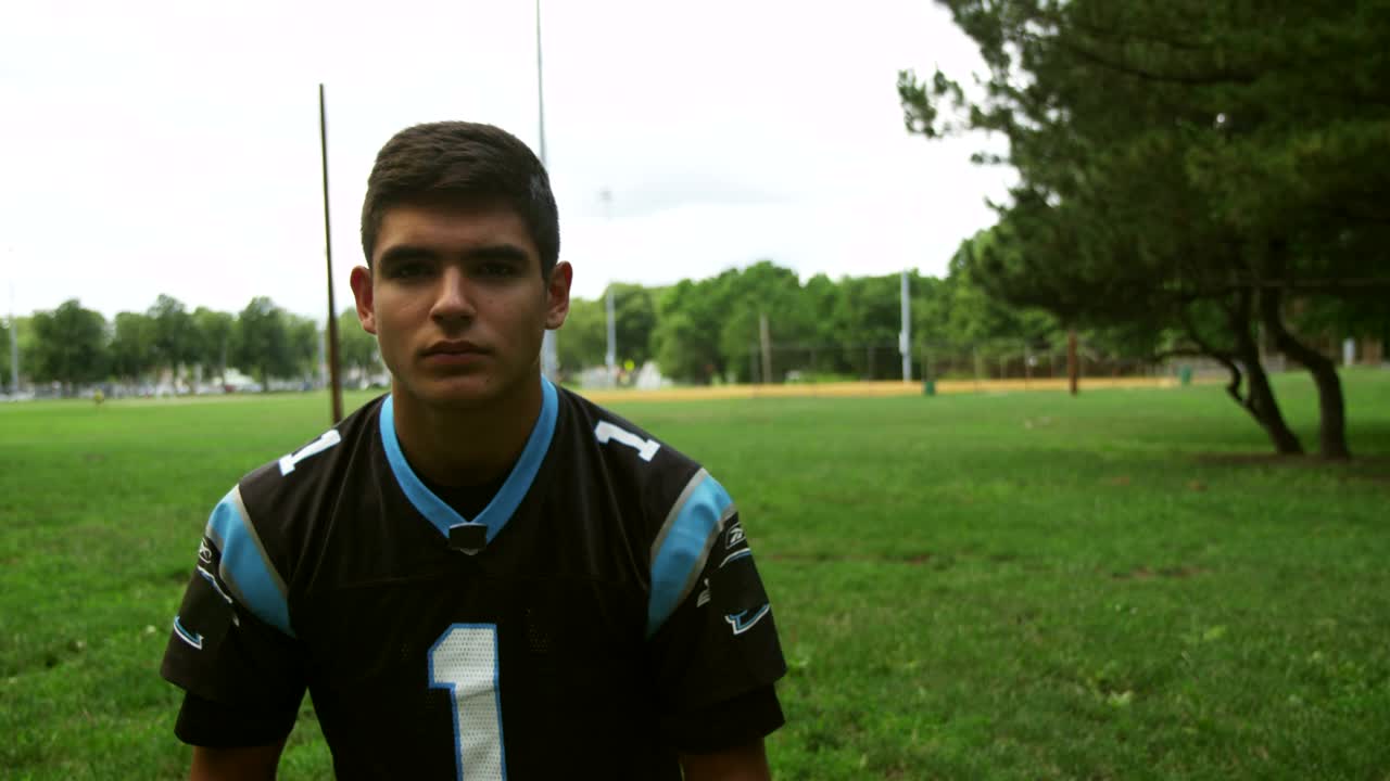 Stock Video Football Player Putting On A Blue Helmet Live Wallpaper For PC - Free Download