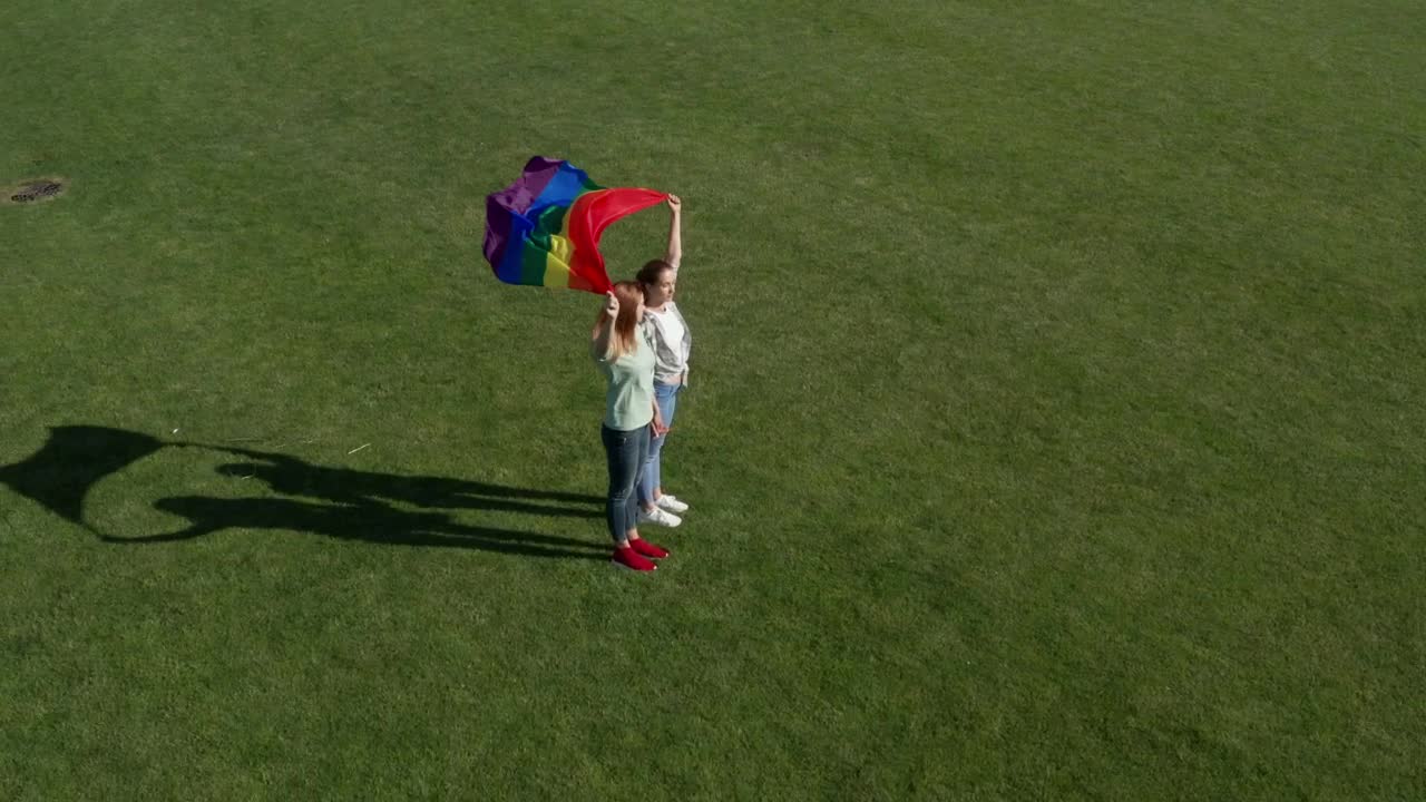 Stock Video Couple Holding A Rainbow Flag In The Wind Live Wallpaper For PC - Free Download