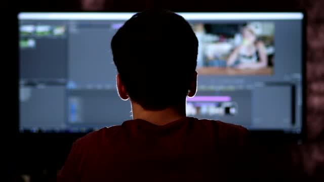 Stock Footage Video Editor Working On A Large Screen Smalllive Wallpaper - Free Download