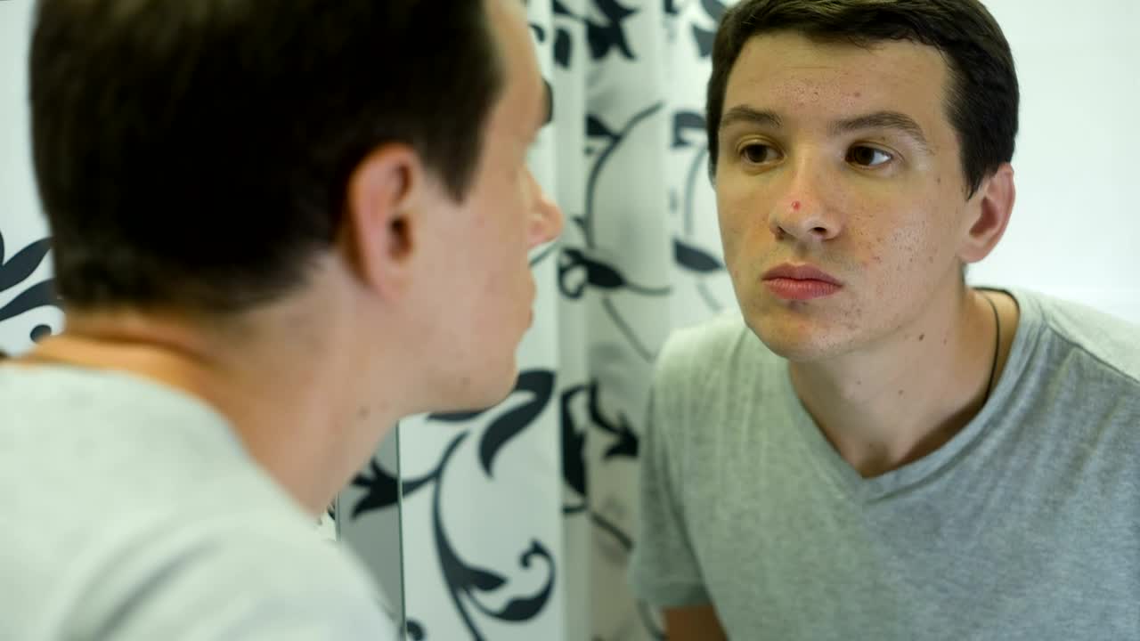 Stock Video Man Unhappy About The Skin Of His Fac Animated Wallpaper - Free Download