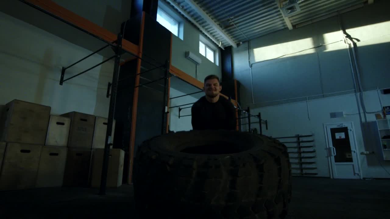 Stock Video Man Doing Crossfit Exercises With A Big Tire Animated Wallpaper - Free Download