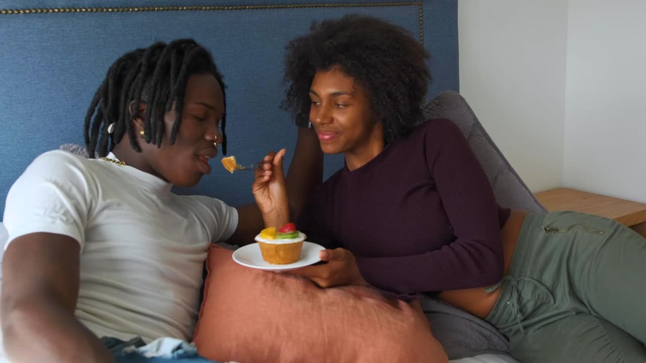 Stock Video Lovers Lying On A Bed Eating A Dessert Animated Wallpaper - Free Download
