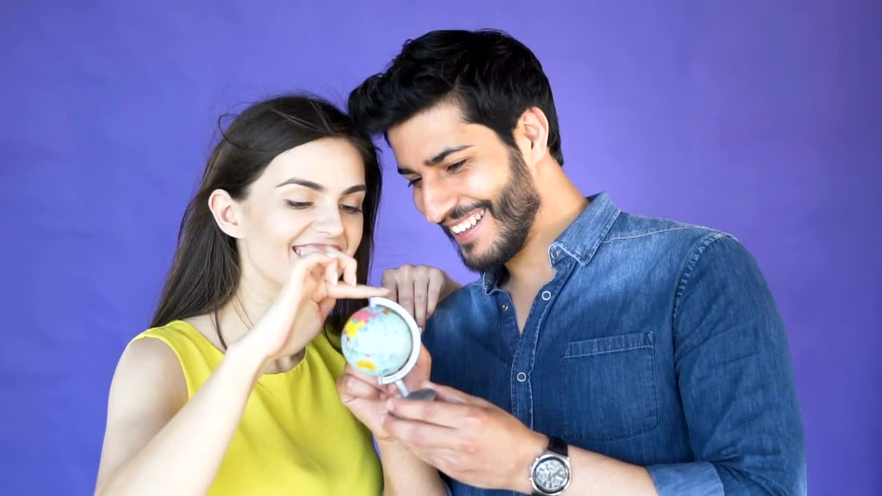 Stock Video Couple Choosing A Place To Travel With A Globe Live Wallpaper For PC - Free Download