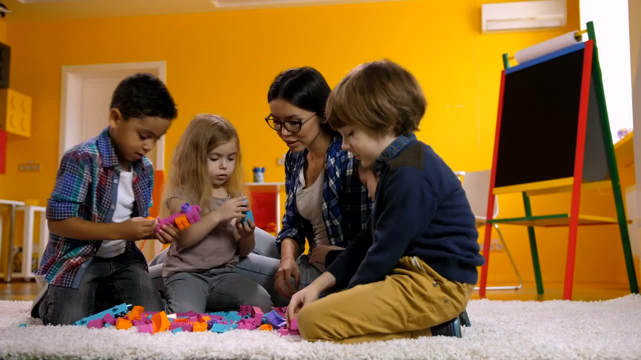 Free Video Stock teacher with little children playing with legos Live Wallpaper - Free Download