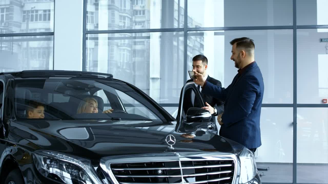 Free Video Stock taking a picture of the new car in the dealership Live Wallpaper - Free Download