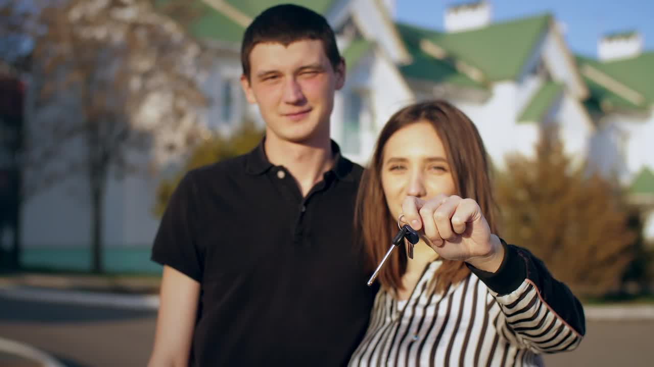 Stock Video Couple Happily Showing Keys To Their New House Live Wallpaper For PC - Free Download