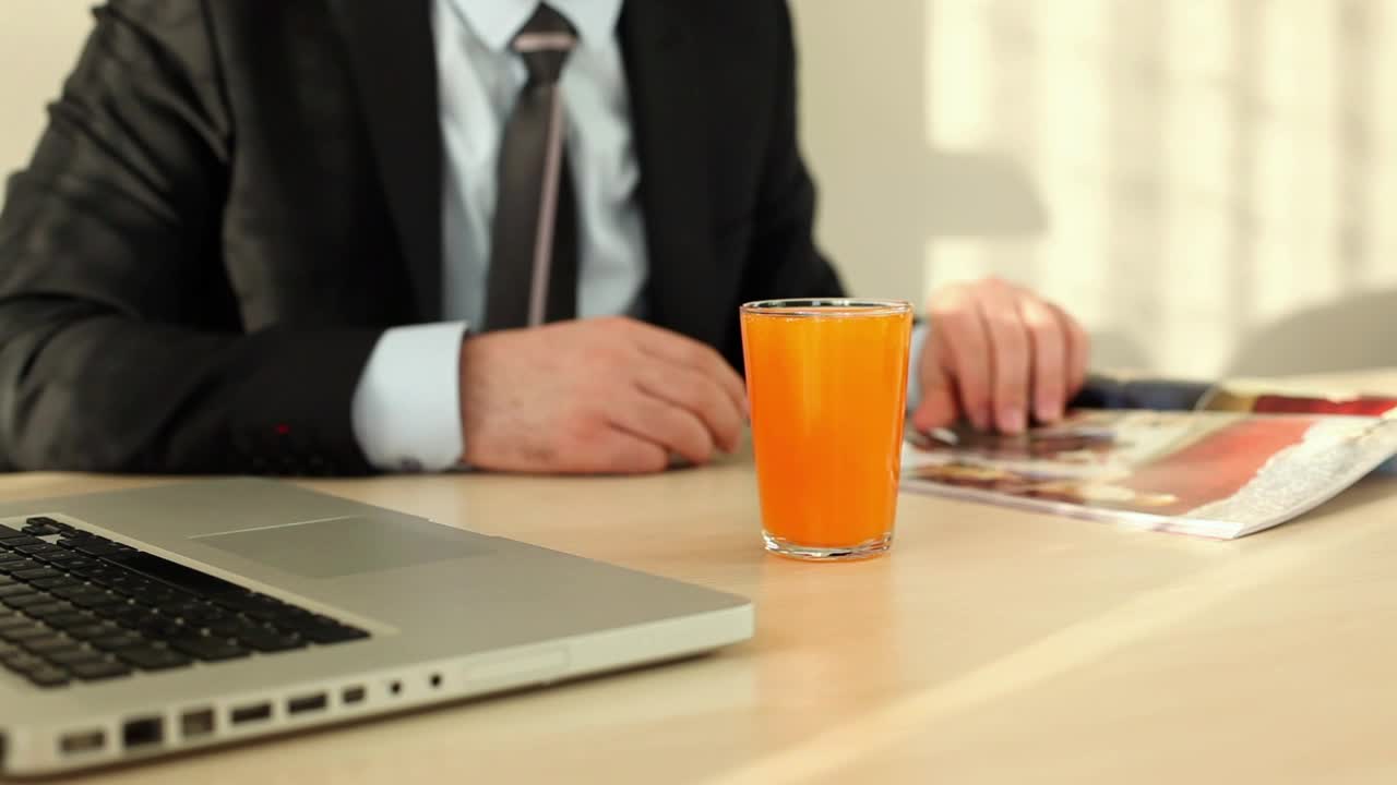 Stock Video Man In Suit Flipping Through A Magazin Animated Wallpaper - Free Download