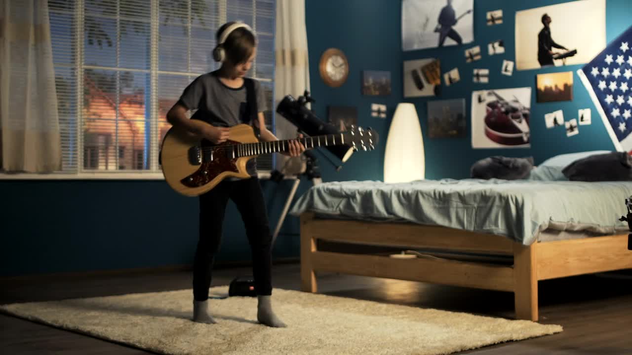 Free Video Stock teen boy playing the guitar on the bedroom Live Wallpaper - Free Download
