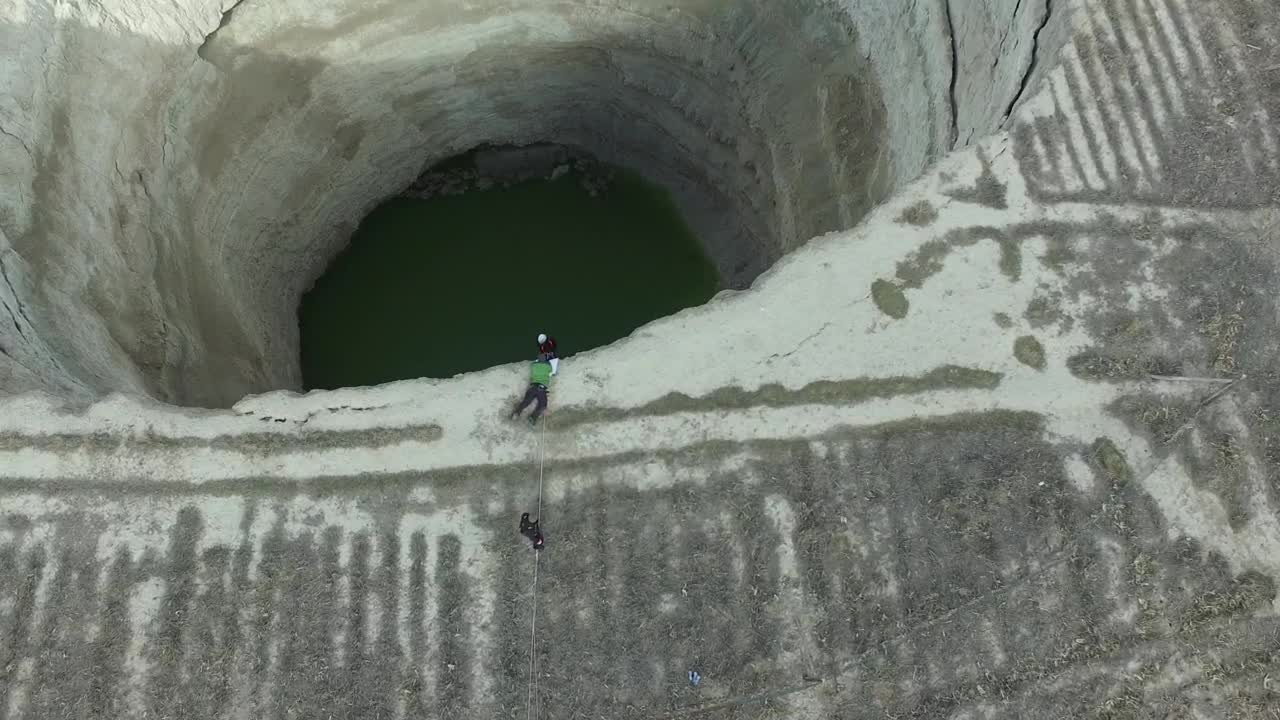 Stock Video Explorer Descending In A Deep Sinkhole Live Wallpaper For PC - Free Download