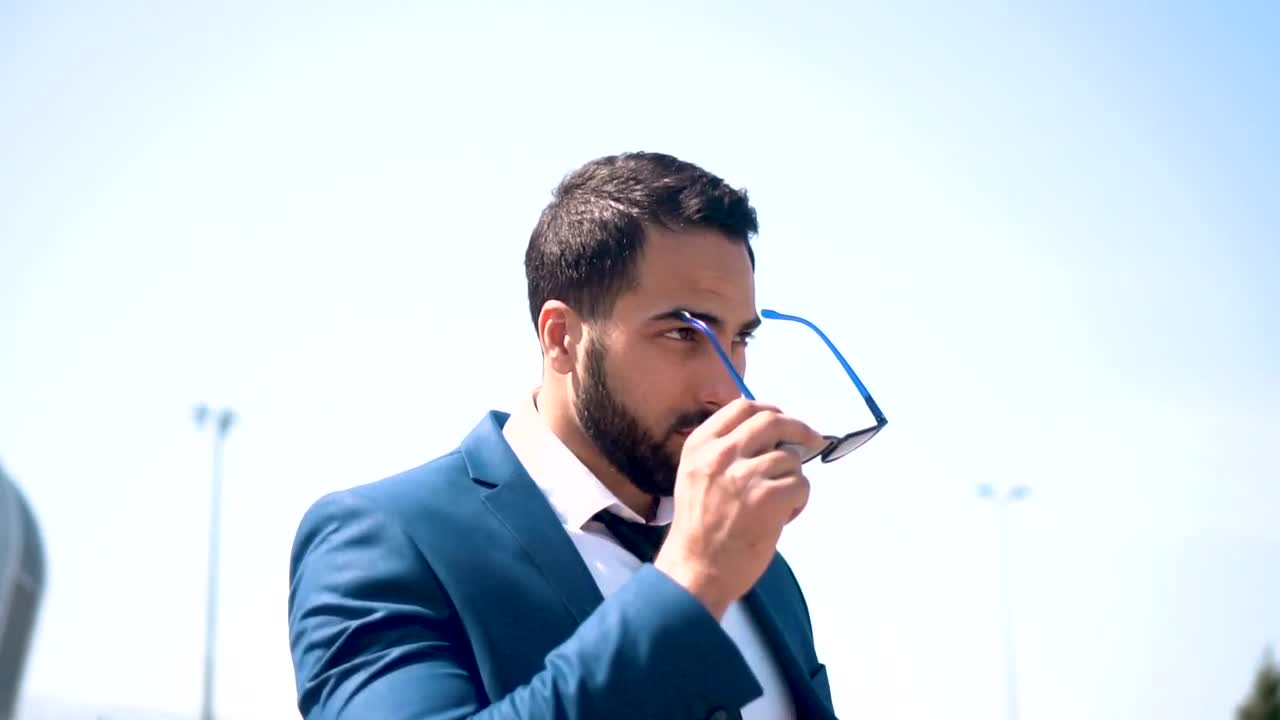 Stock Video Lawyer Puts On Sunglasses In Front Of Modern Building Animated Wallpaper - Free Download